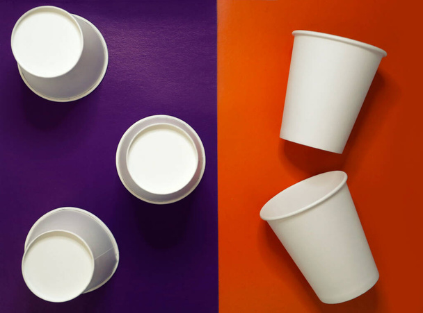 白紙5枚使い捨てコーヒーを飲みにカップを奪う、カラフルな紫とオレンジの背景でお茶トップビュー - 写真・画像