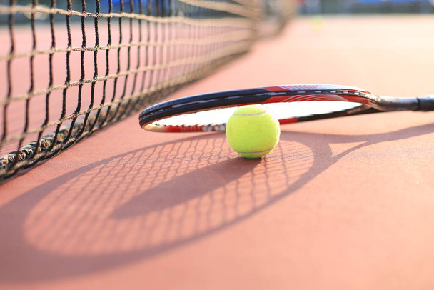 Tennis racket and the ball on tennis court - Fotó, kép