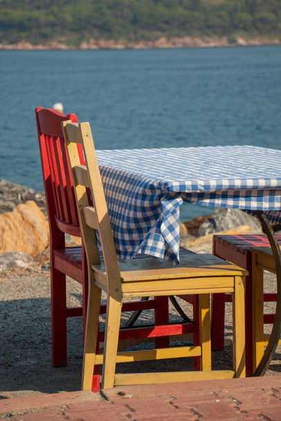 Colorful tables and chairs by the beach - Foto, imagen