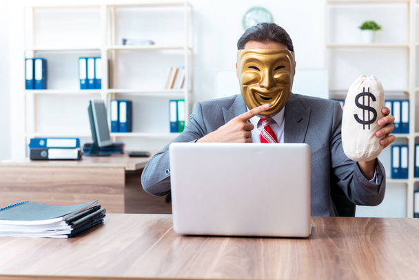 Businessman wearing mask in hypocrisy concept - Photo, Image
