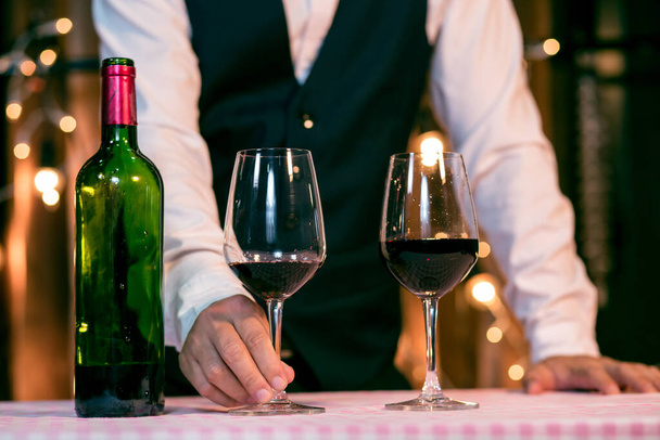 Waitress man pouring wine into glass - Φωτογραφία, εικόνα
