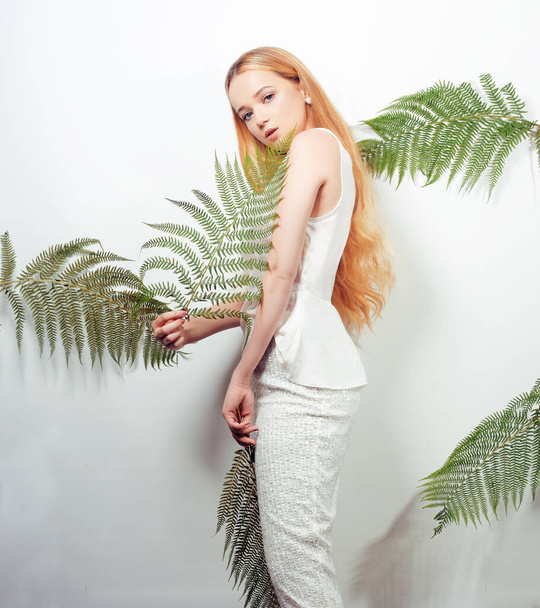 Blonde Total White look. Fashionable model photo posing. Woman in tropical leaves party all in white. The concept of fashion, summer vacation. - Foto, Bild