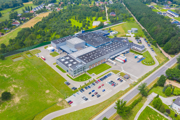 Aerial view of goods warehouse. Logistics center in industrial city zone from above. Aerial view of trucks loading at logistic center stock photo - Photo, Image