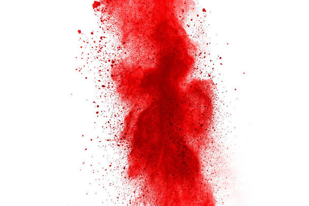 Freeze motion of red powder exploding, isolated on white background. Abstract design of red dust cloud. Particles explosion screen saver, wallpaper - Photo, Image