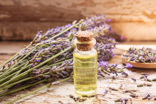 Lavender essential oil in a small bottle. Selective focus. nature. - Fotó, kép