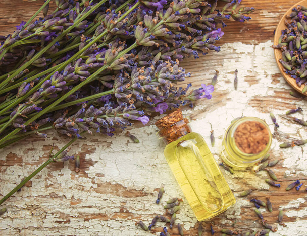 Lavender essential oil in a small bottle. Selective focus. nature. - 写真・画像