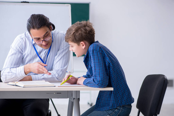 Young male teacher and boy in the classroom - Photo, image