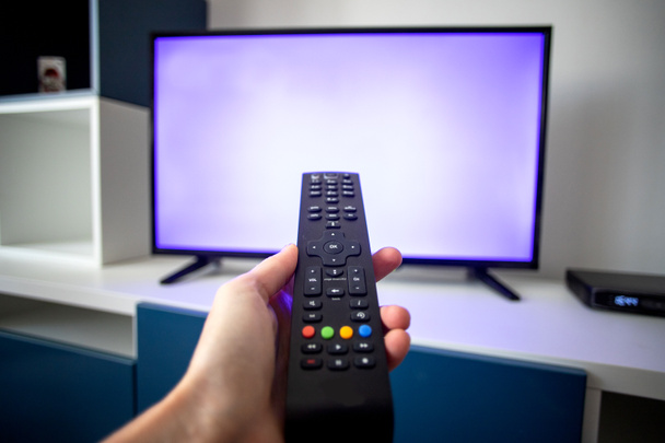 sledování televize doma zaměření na dálkové ovládání - Fotografie, Obrázek