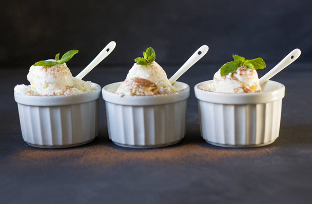 Background of three balls of ice cream in cups. Three servings of ice cream. Fresh ice cream for dessert. Peppermint copyspace - Photo, Image