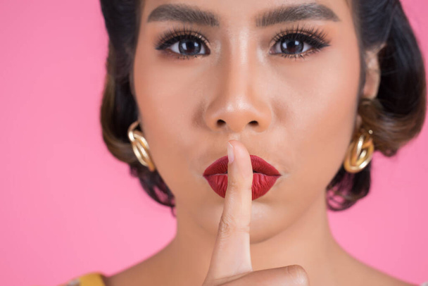 Beauty asian woman red lips and finger showing hush silence sign - Photo, Image