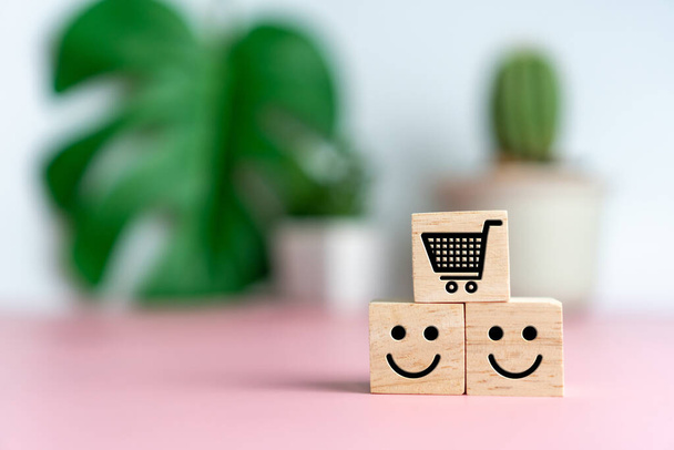 Lächelndes Gesicht und Wagensymbol auf Holzwürfel. Optimistische Person oder Menschen, die sich im Inneren fühlen und Bewertung des Service beim Einkaufen, Zufriedenheitskonzept im Geschäft. - Foto, Bild