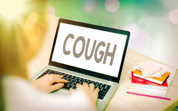 Conceptual hand writing showing Cough. Business photo showcasing sudden expulsion of air throughout the passages to clear airways Modern gadgets white screen under colorful bokeh background. - Photo, Image