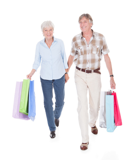 Seniors Couple Walking With Shopping Bag - Photo, Image