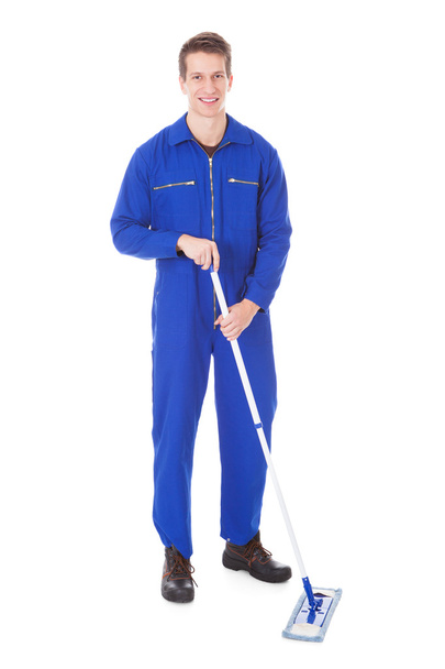 Worker In Boilersuit Cleaning Floor - Foto, afbeelding
