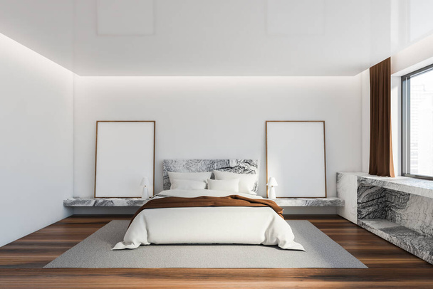 Interior of Scandinavian master bedroom with white walls, comfortable king size bed with white and brown bedding and marble shelf under window with blurry cityscape. Two mock up posters. 3d rendering - Photo, Image