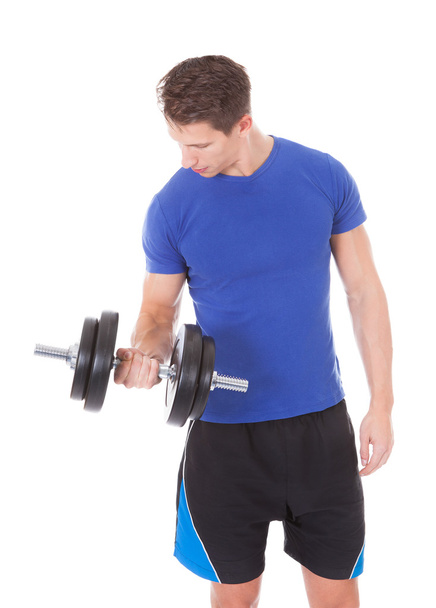 Young Man Exercising With Dumbbells - Foto, Bild