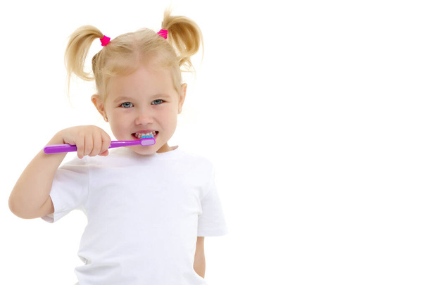 A little girl brushes her teeth. - Foto, imagen
