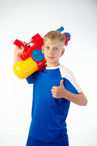 boy with water pistol on white background - Photo, Image