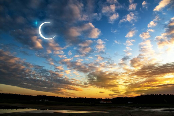 New moon. Prayer time. Generous Ramadan. Sunset in the clouds and new moon. tranquility of the nature background - Photo, Image