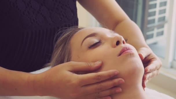 Woman gets facial and head massage in luxury spa. - Metraje, vídeo