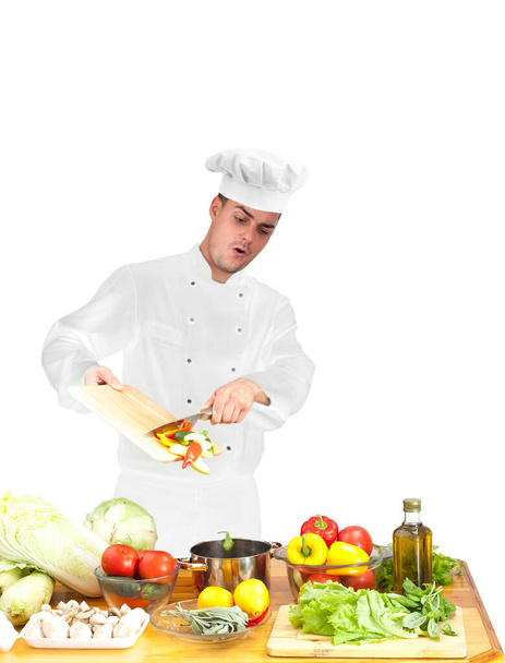 Portrait of young chef  cooking vegetables  in restaurant kitchen, copy space.  - Foto, immagini