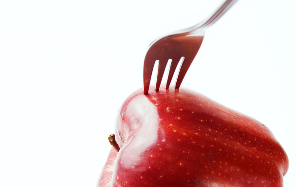 Apfel mit gesteckter Gabel - Foto, Bild