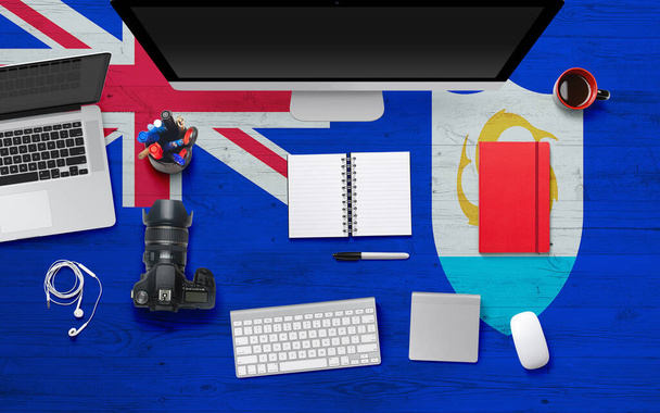 Anguilla flag background with headphone,camera, notebook and mouse on national office desk table.Top view with copy space.Flat Lay. - Φωτογραφία, εικόνα