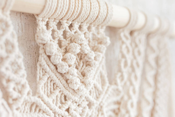 Close-up of hand made macrame texture pattern.  ECO friendly modern knitting DIY natural decoration concept  in the interior. Flat lay. Handmade macrame 100% cotton. Details close up. Female hobby.  - Valokuva, kuva