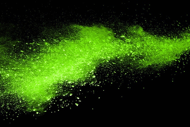 The movement of abstract dust explosion frozen green on black background. Stop the movement of powdered green on black background. Explosive powder green on black background. - Φωτογραφία, εικόνα
