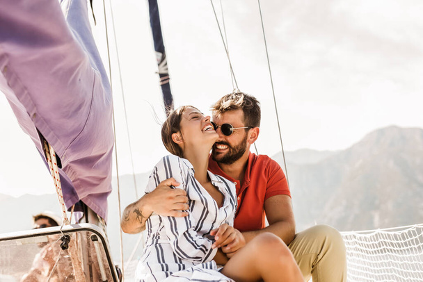 Loving couple spending happy time on a yacht at sea. Luxury vacation on a seaboat.  - Photo, Image