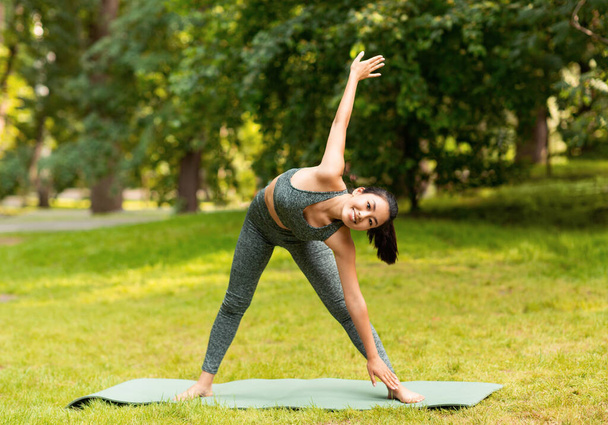 Belle fille asiatique le matin yoga pratique au parc de la ville - Photo, image