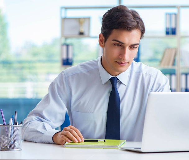 Young handsome businessman employee working in office at desk - Photo, Image