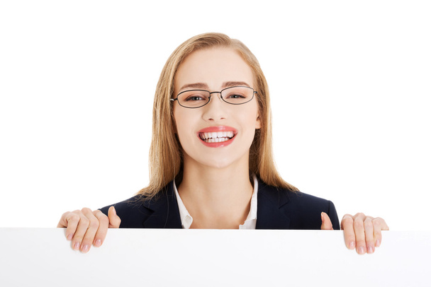 Beautiful business woman holding empty board, copy space. - Photo, Image