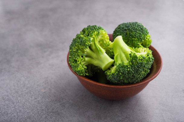 Fresh raw green broccoli on a table. Diet healthy product. - Zdjęcie, obraz