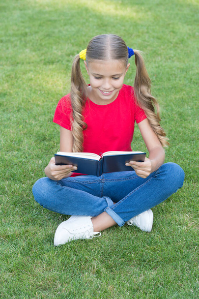 I love to read. Happy reader summer outdoors. Little child read book on green grass. Summer reading list. Fantasy and fiction. Literature and poetry. Kid who reads. Lets read - Фото, изображение