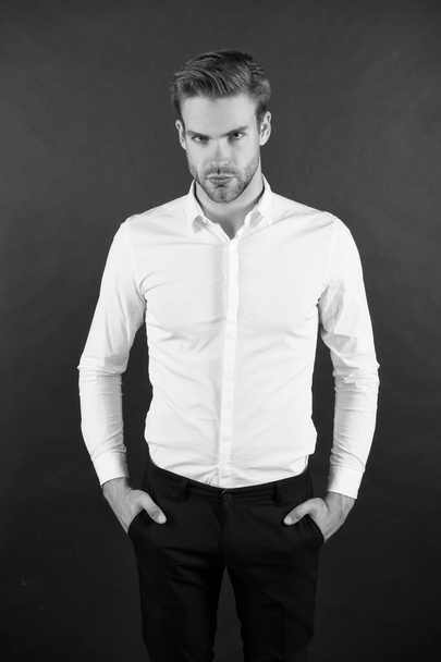 Wear it simple. White shirt and black pants. Serious man dark background. Fashion look of handsome guy. Fashion model in classic style. Fashion and style. Ready to go fashion wardrobe - Zdjęcie, obraz