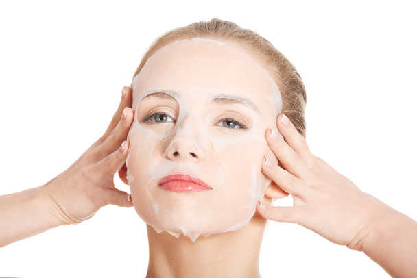 Beautiful young woman with collagen mask. - Zdjęcie, obraz