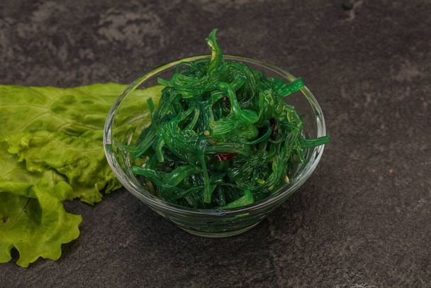 Green Chuka Seaweed Salad Isolated on White Background Top View. Wakame Sea Kelp Salat, Chukka Sea Weed, Healthy Algae Food - Photo, Image