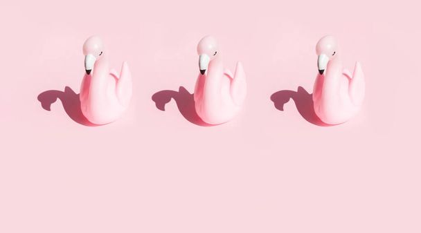 Pink flamingo on pink background. Concept of summer holidays and travel - Photo, image