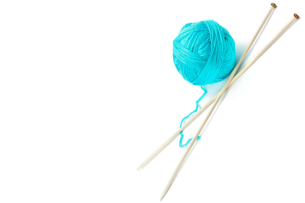 Ball of woolen thread and knitting needles isolated on white background. The concept is hobbies and handicrafts. Free space for text. - Photo, Image