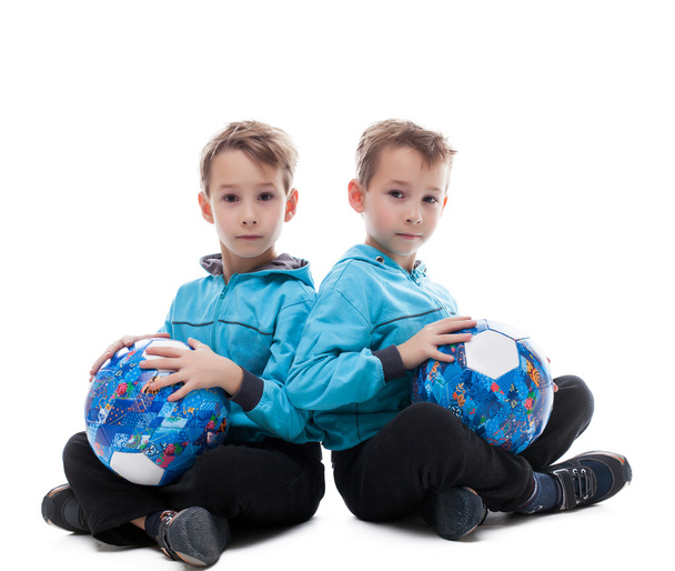 Image of amusing twin brothers posing with balls - Valokuva, kuva
