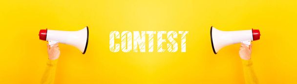 megaphones and inscription contest on yellow background, panoramic image - Photo, Image