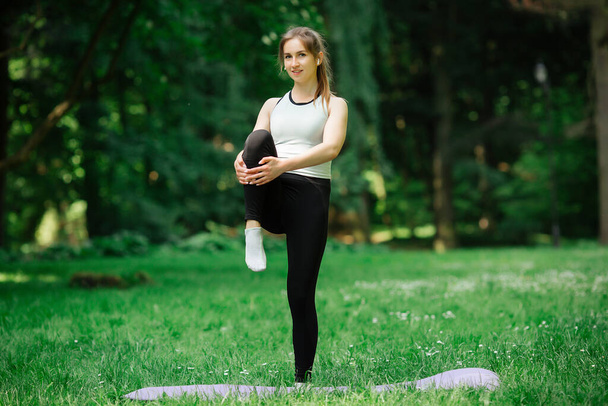 young sexy girl goes in for sports in nature - Fotó, kép