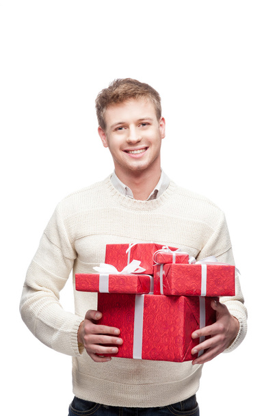 young casual man hoding christmas gift - Фото, изображение