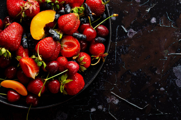 fresh berries on dark background in the - Zdjęcie, obraz