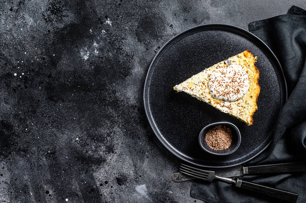 Cottage cheese casserole with chocolate on a plate. Black background. Top view. Copy space. - Photo, image