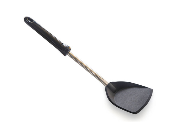 Modern non stick spade of frying pan or spatula in black color and stainless steel on white isolated background with clipping path. Perfect studio shot cookware and utensils concept for cooking food. - Photo, Image