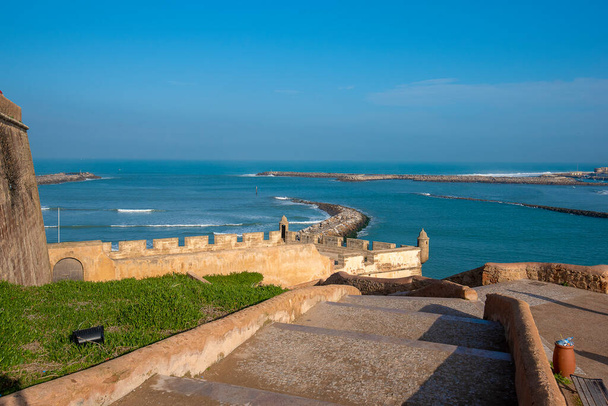 The Kasbah of the Udayas ( Oudayas ) ancient fortress in Rabat in Morocco is located at the mouth of the Bou Regreg river. the capital of Morocco.View of fortified walls front of the ocean beach - 写真・画像