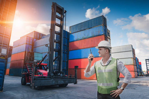 Container Logistics Shipping Management of Transportation Industry, Transport Engineer Control Via Walkie-Talkie to Worker in Containers Shipyard. Business Cargo Ship Import / Eksport Factory Logistic. - Zdjęcie, obraz