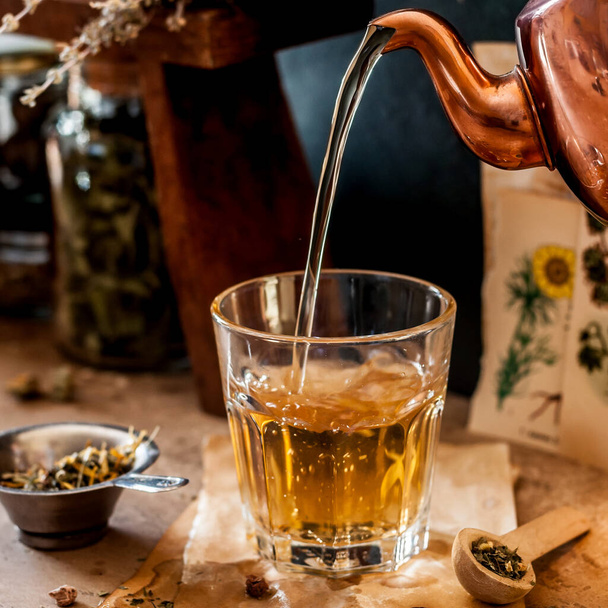 Pouring Herbal Tea into a Glass, Variety of Dried Herb Mixes, square - Foto, Imagen